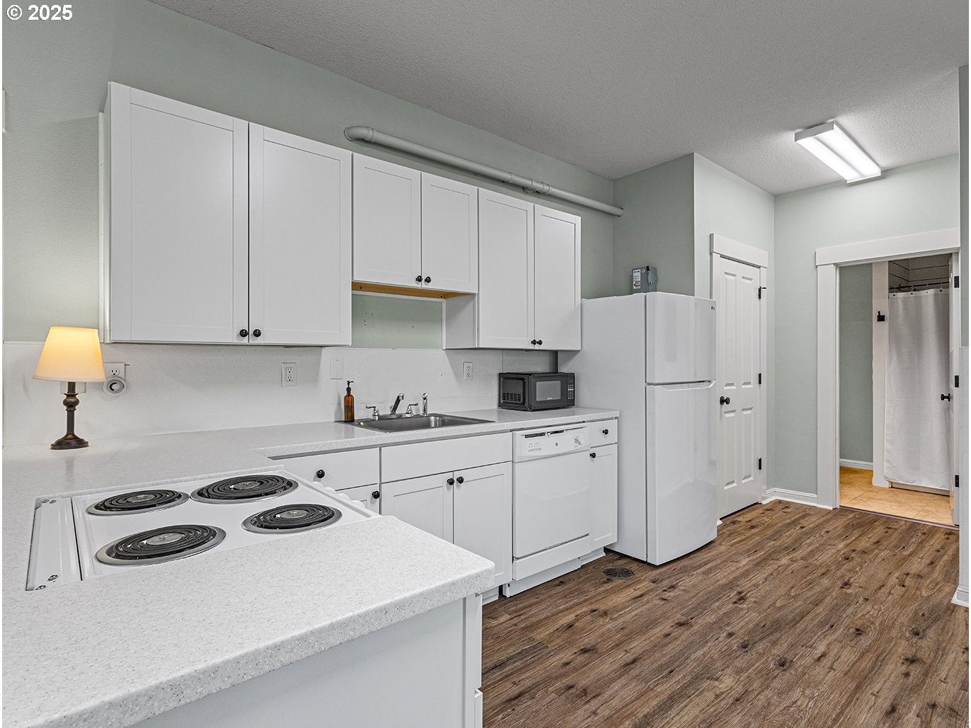 179 Southeast 46th Drive Gresham, OR 97080 - Photo 31 of 39 a kitchen with a sink a stove a refrigerator and white cabinets
