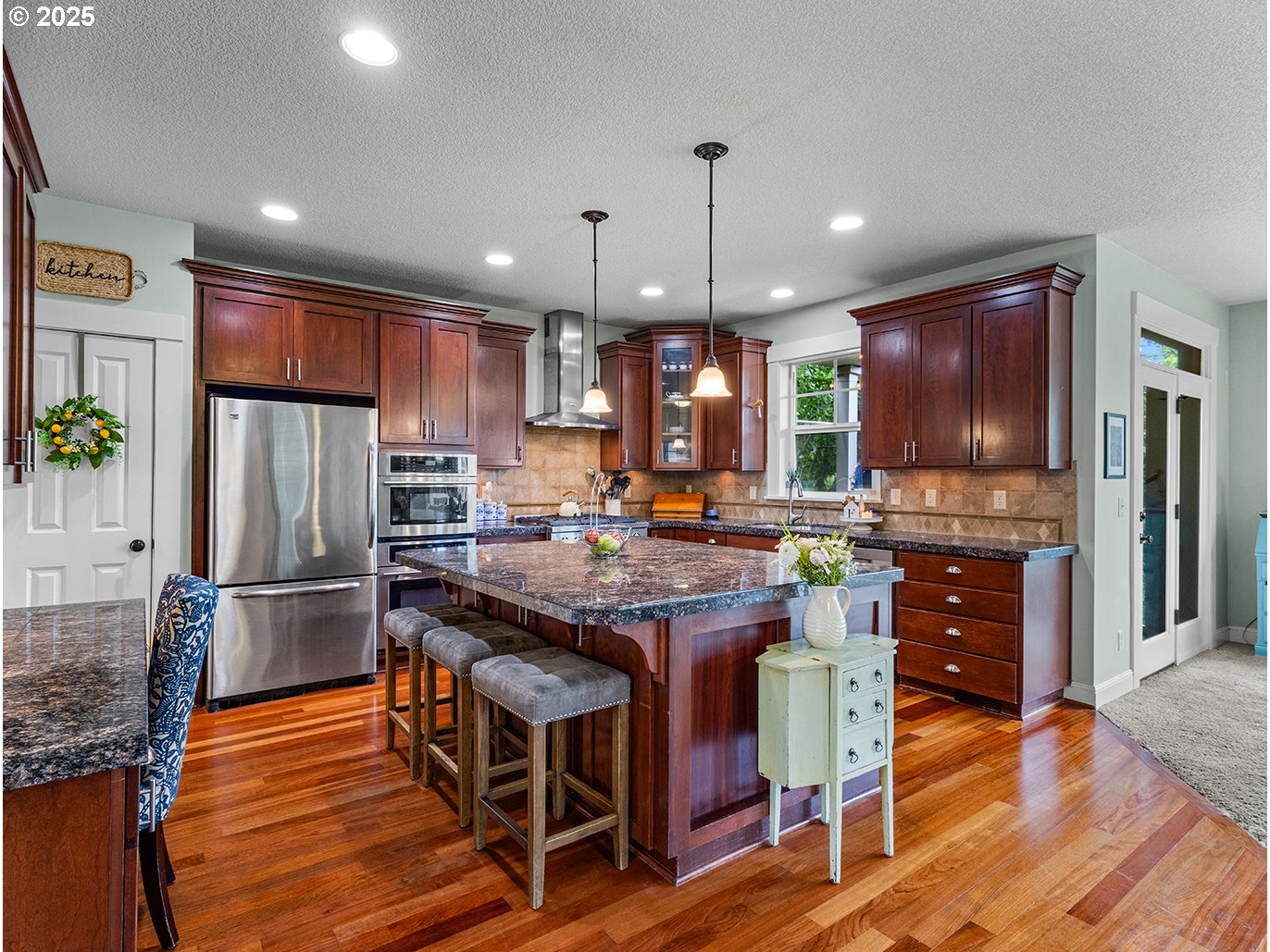 179 Southeast 46th Drive Gresham, OR 97080 - Photo 9 of 39 a kitchen with stainless steel appliances granite countertop a table chairs refrigerator and microwave