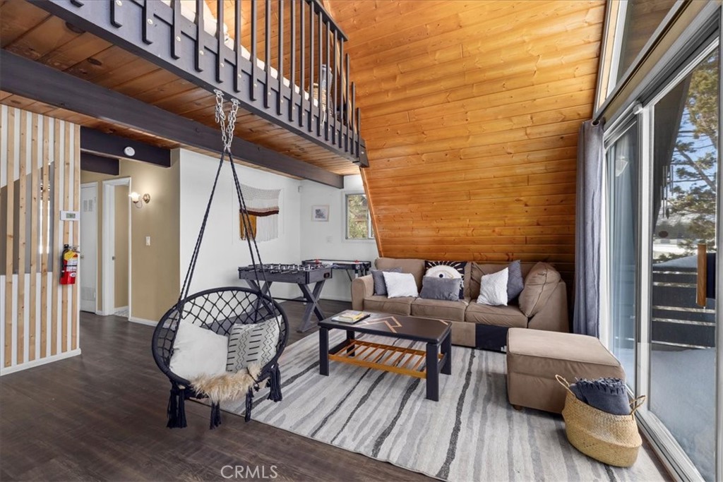 113 East Fairway Boulevard Big Bear City, CA 92314 - Photo 11 of 36 a outdoor living room with furniture and wooden floor