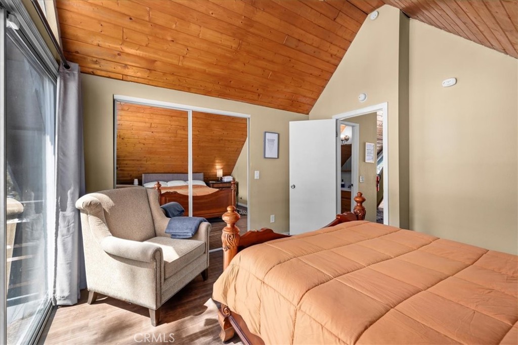 113 East Fairway Boulevard Big Bear City, CA 92314 - Photo 14 of 36 a bed room with a bed and a couch