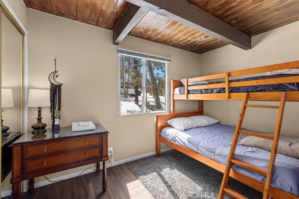 113 East Fairway Boulevard Big Bear City, CA 92314 - Photo 22 of 36 a bedroom with a bed and a window