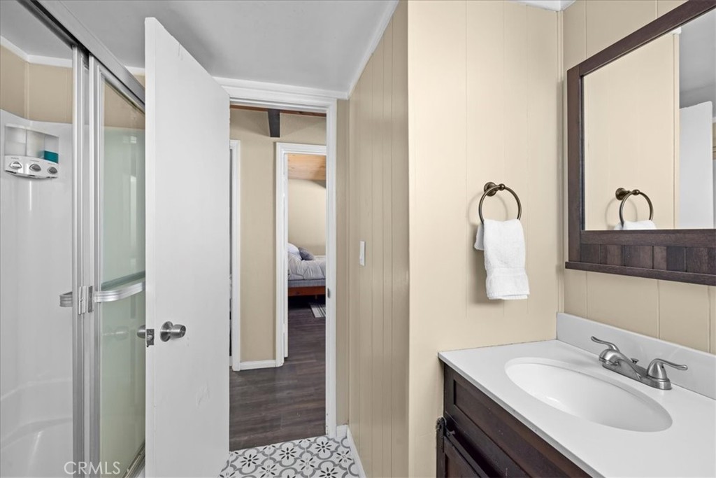 113 East Fairway Boulevard Big Bear City, CA 92314 - Photo 24 of 36 a bathroom with a sink vanity and a mirror