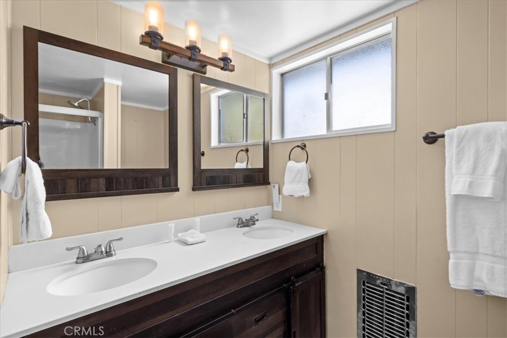 113 East Fairway Boulevard Big Bear City, CA 92314 - Photo 25 of 36 a bathroom with a sink and a mirror