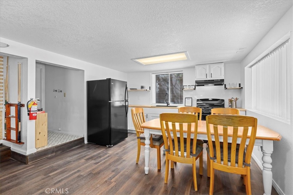 113 East Fairway Boulevard Big Bear City, CA 92314 - Photo 27 of 36 a kitchen with stainless steel appliances granite countertop a dining table and chairs