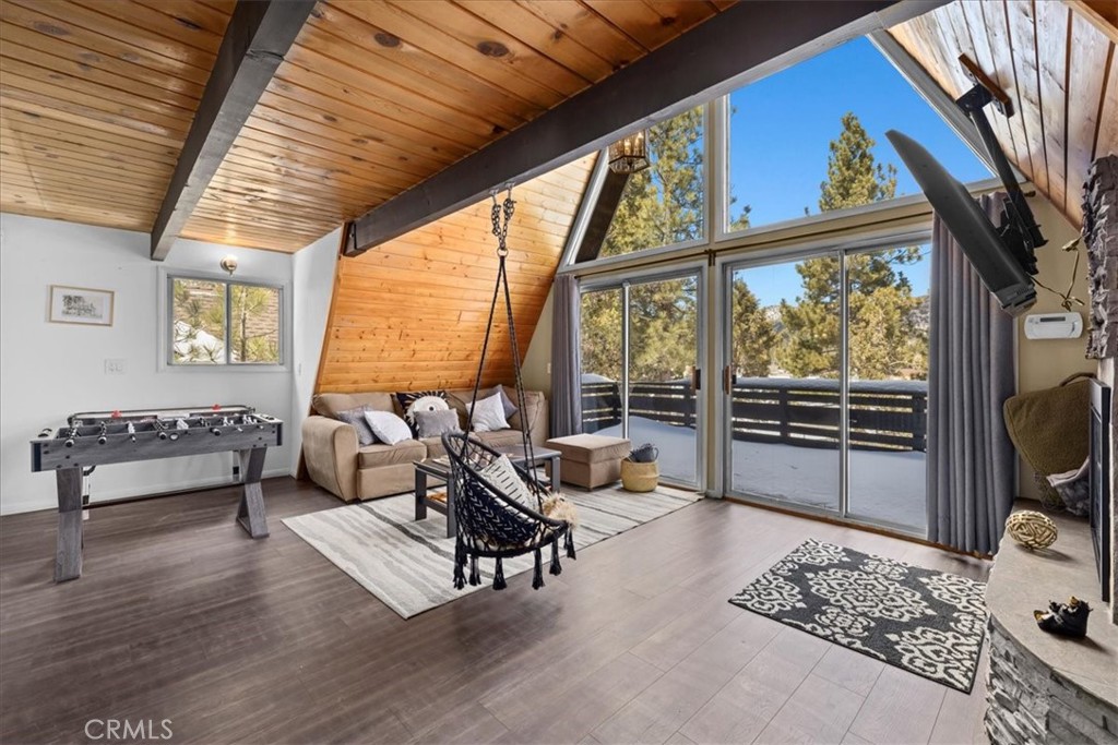 113 East Fairway Boulevard Big Bear City, CA 92314 - Photo 6 of 36 a living room with furniture a flat screen tv and a large window