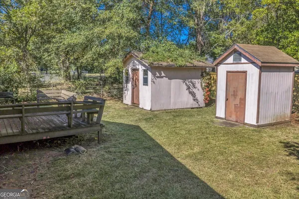a backyard of a house with table and chairs