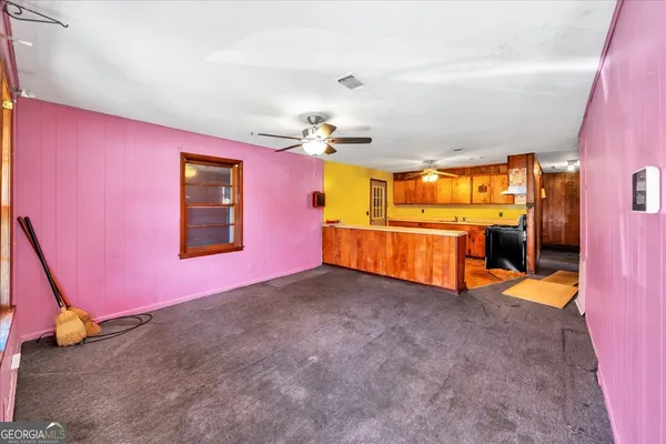 a view of a livingroom with a fireplace and a chandelier