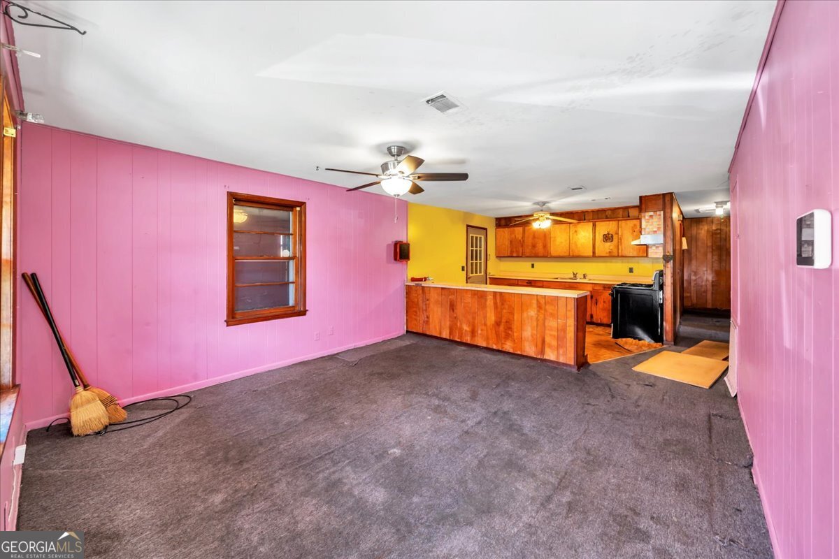 805 East Church Street Fort Valley, GA 31030 - Photo 6 of 14 a view of a livingroom with a fireplace and a chandelier