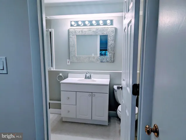 a view of a backyard with potted plants and large tree