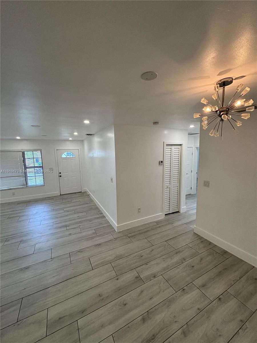 17110 Northwest 11th Avenue Miami Gardens, FL 33169 - Photo 11 of 38 an empty room with wooden floor and windows