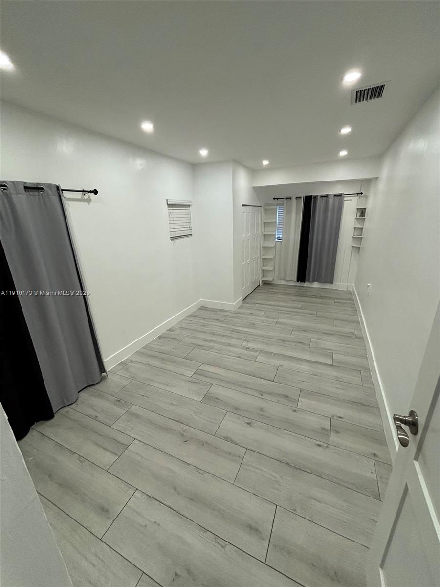 17110 Northwest 11th Avenue Miami Gardens, FL 33169 - Photo 21 of 38 a large white room with wooden floor