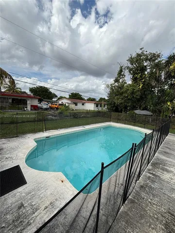 a view of a swimming pool with a yard