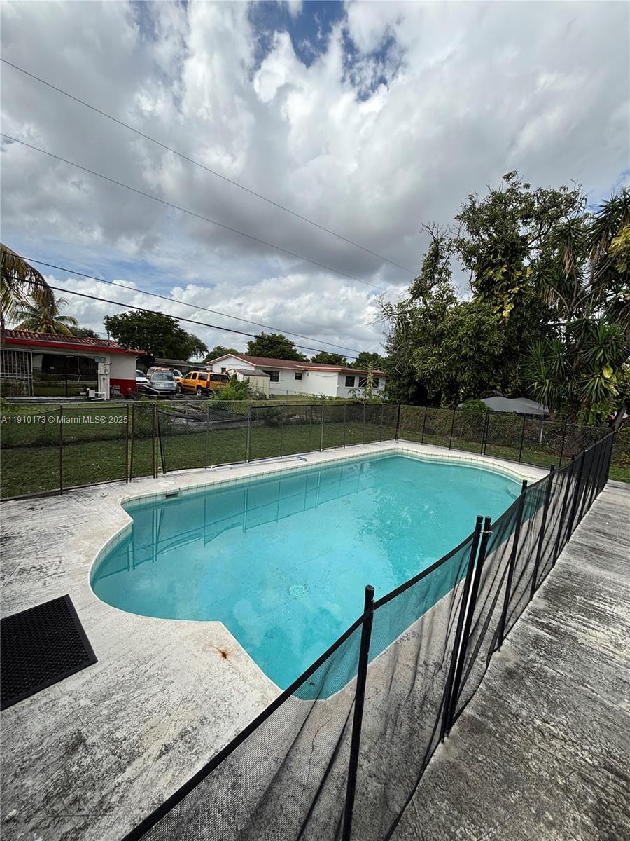 17110 Northwest 11th Avenue Miami Gardens, FL 33169 - Photo 29 of 38 a view of a swimming pool with a yard