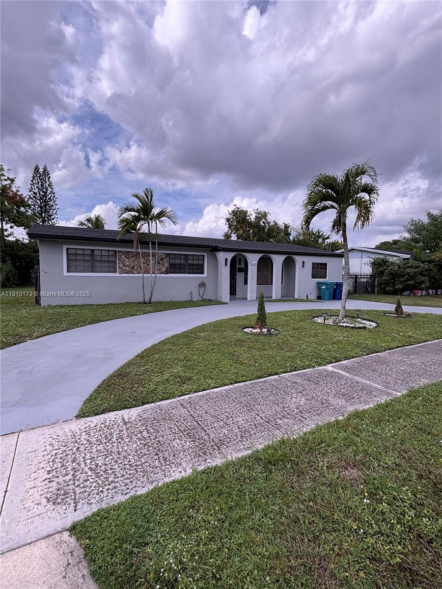 17110 Northwest 11th Avenue Miami Gardens, FL 33169 - Photo 30 of 38 a view of a big yard in front of the house