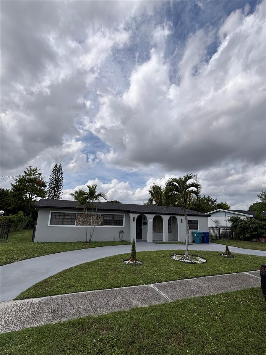 17110 Northwest 11th Avenue Miami Gardens, FL 33169 - Photo 31 of 38 a view of a big house with a big yard plants and large trees