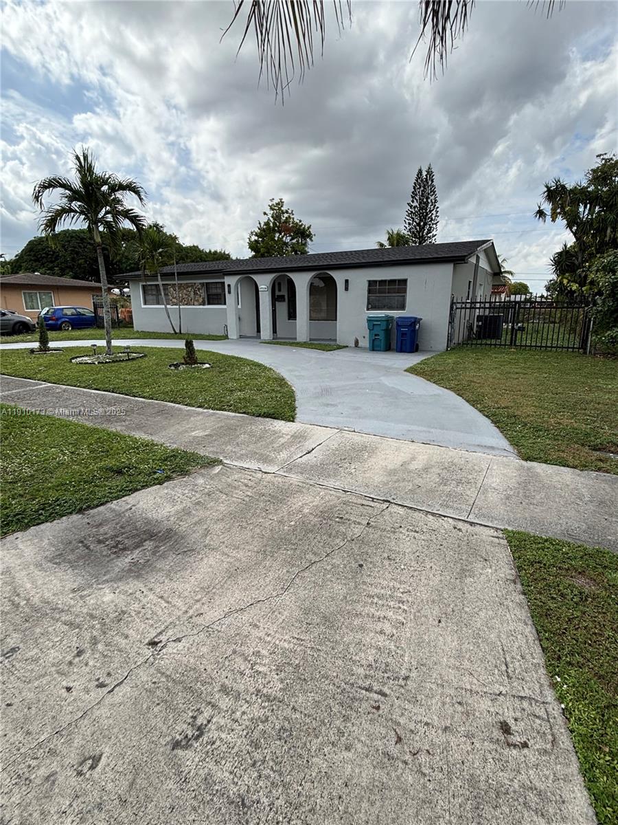 17110 Northwest 11th Avenue Miami Gardens, FL 33169 - Photo 32 of 38 front view of a house with a yard