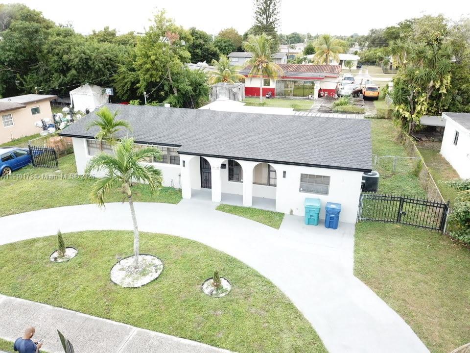 17110 Northwest 11th Avenue Miami Gardens, FL 33169 - Photo 36 of 38 a view of a house with swimming pool and a yard