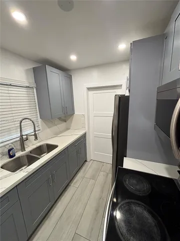 a kitchen with stainless steel appliances a sink stove and refrigerator