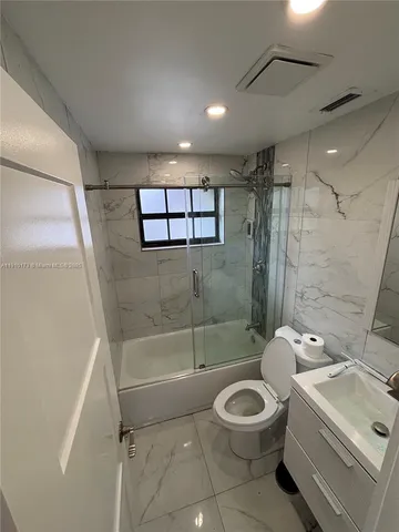 a bathroom with a toilet sink and shower