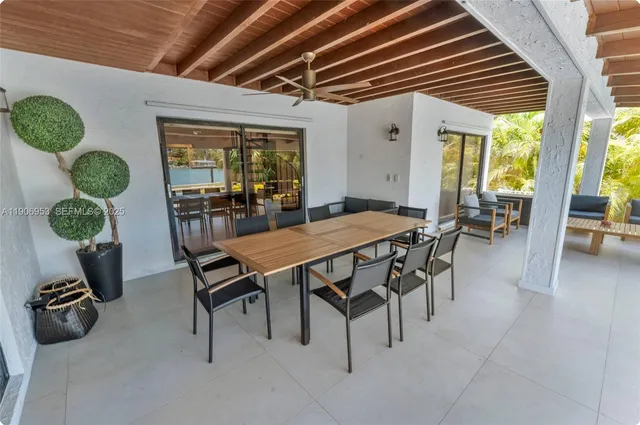 a dining room with furniture and a large window