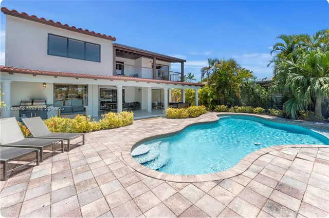 a view of a house with backyard porch and sitting area