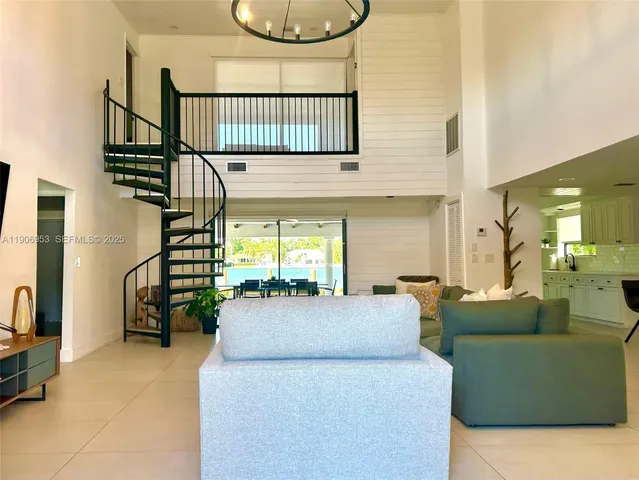 a living room with furniture a rug and white walls