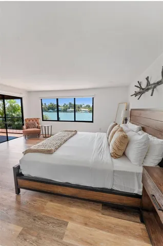 a bedroom with a large bed and a large window