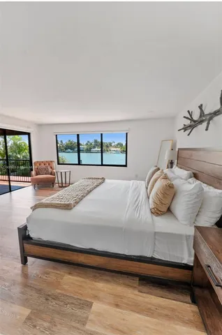 a bedroom with a large bed and a night stand