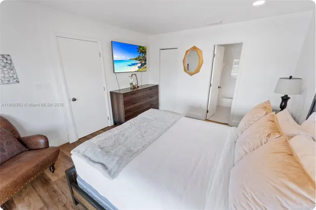 a bedroom with a bed and couch