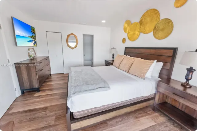 a bed room with a bed and painting on the wall