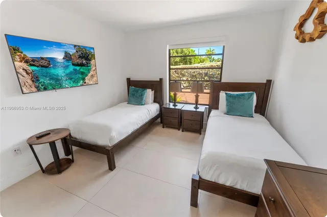 a bedroom with furniture and a window