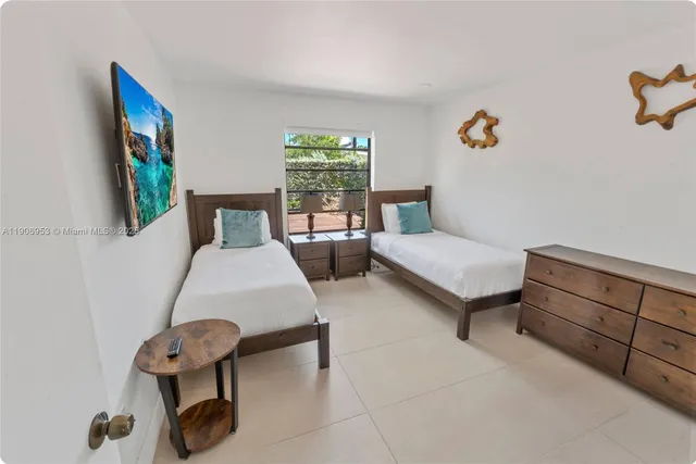 a bedroom with furniture and a window