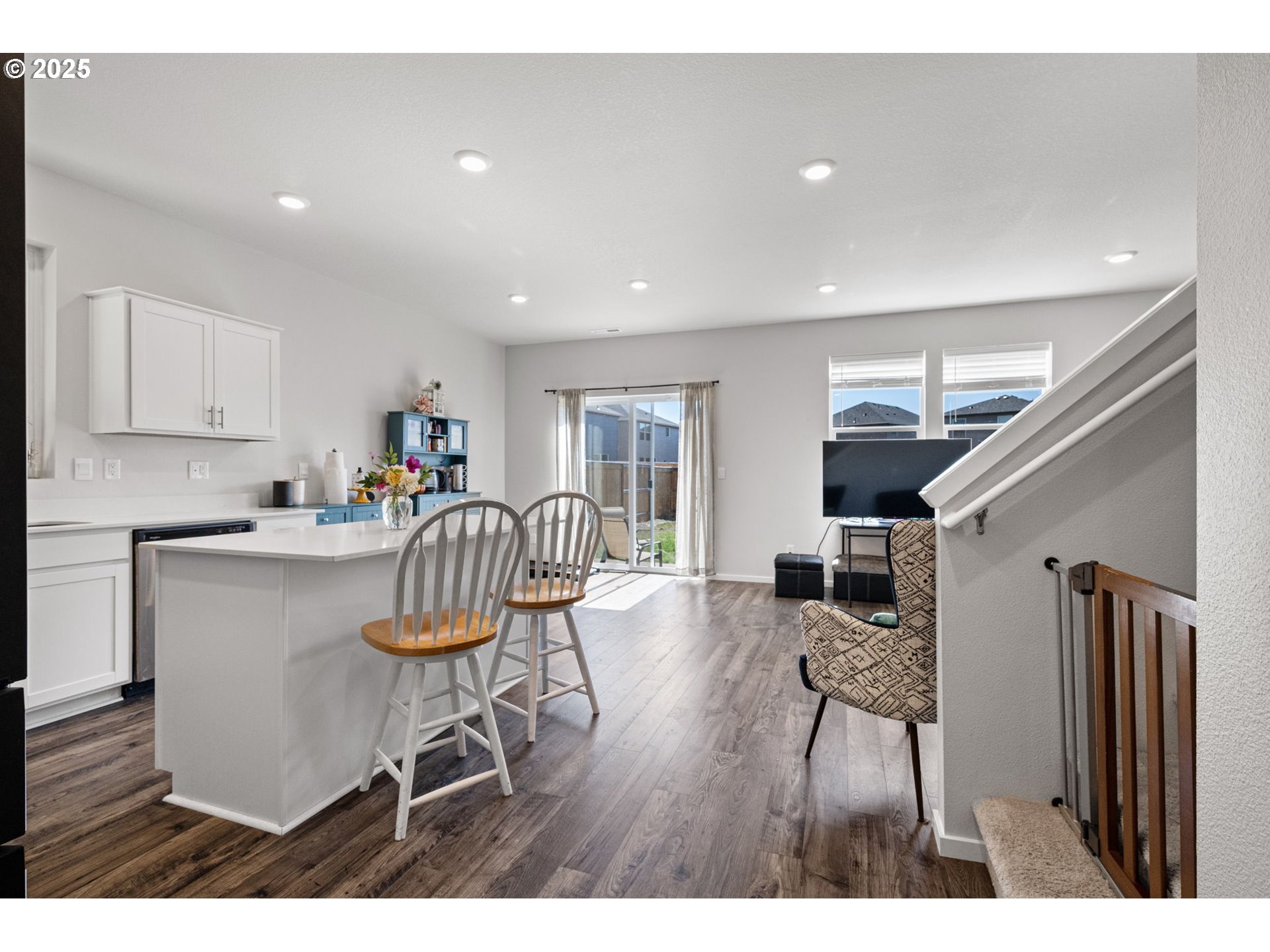 2987 V Street Springfield, OR 97477 - Photo 13 of 45 a kitchen with stainless steel appliances kitchen island granite countertop a dining table chairs and a refrigerator