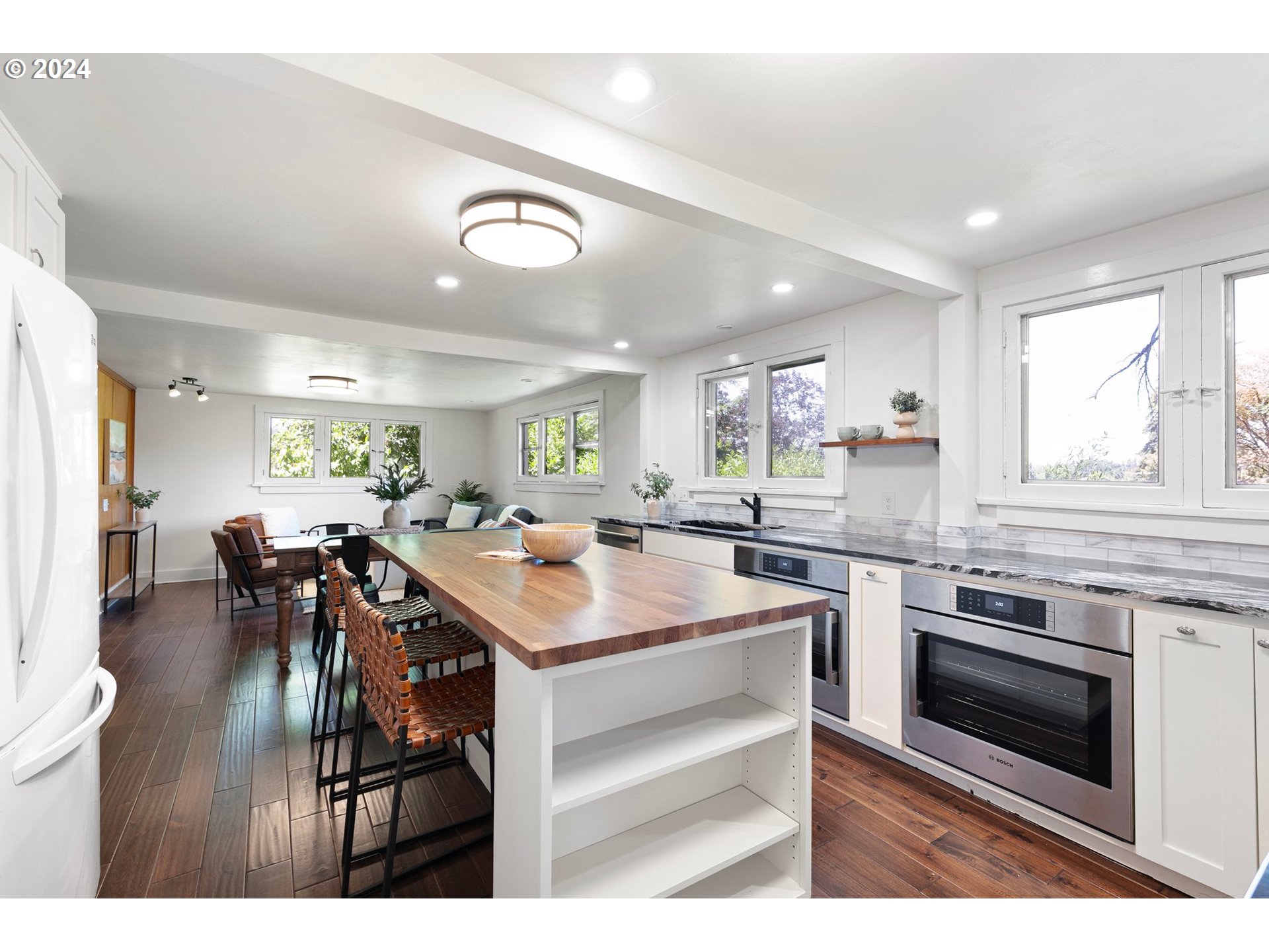2919 Jefferson Street Eugene, OR 97405 - Photo 14 of 38 a kitchen with a table chairs and white cabinets