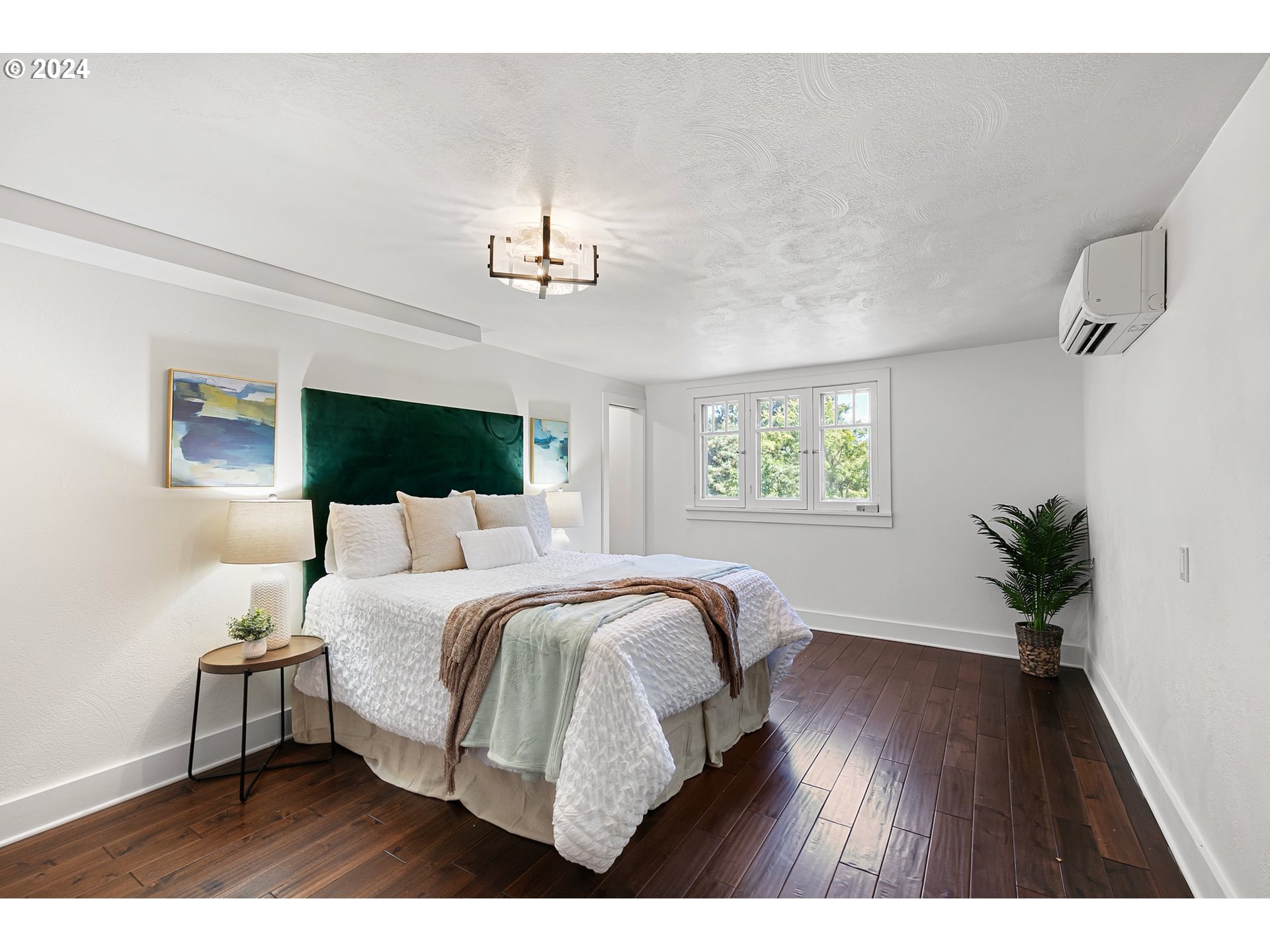 2919 Jefferson Street Eugene, OR 97405 - Photo 18 of 38 a bedroom with a large bed and a wooden floor