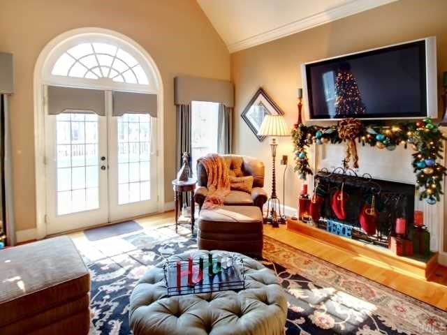 13709 Possum Track Road Raleigh, NC 27614 - Photo 3 of 12 Vaulted Family Room with site finished hardwood floors! Cozy up to the fireplace and enjoy your brand new home theater system watching the 55" TV! French doors lead to a multi level deck outside! 3.4 acres of land! Enjoy Enjoy Enjoy!