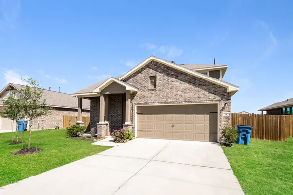a front view of a house with a garden and plants