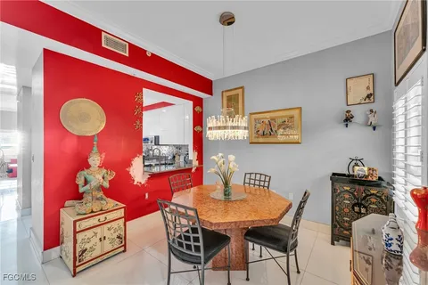 a view of a dining room with furniture a chandelier and wooden floor