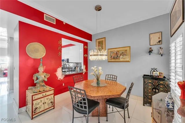 a view of a dining room with furniture a chandelier and wooden floor