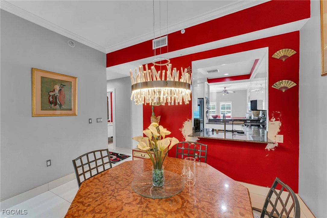 2080 West First Street, Unit 109 Fort Myers, FL 33901 - Photo 14 of 47 a view of a dining room with furniture a chandelier and wooden floor