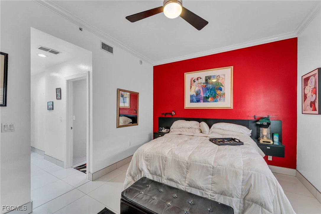 2080 West First Street, Unit 109 Fort Myers, FL 33901 - Photo 24 of 47 a bed room with a bed and a painting on the wall