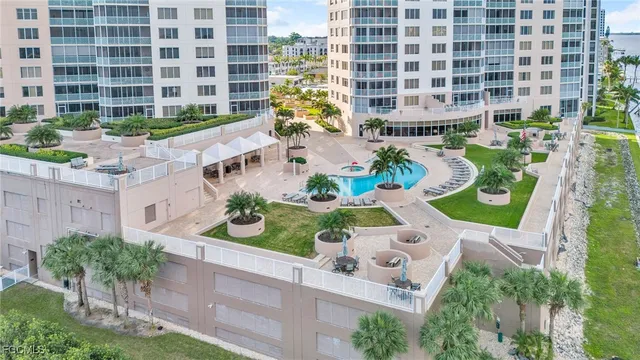 a front view of a multi story residential apartment building with yard