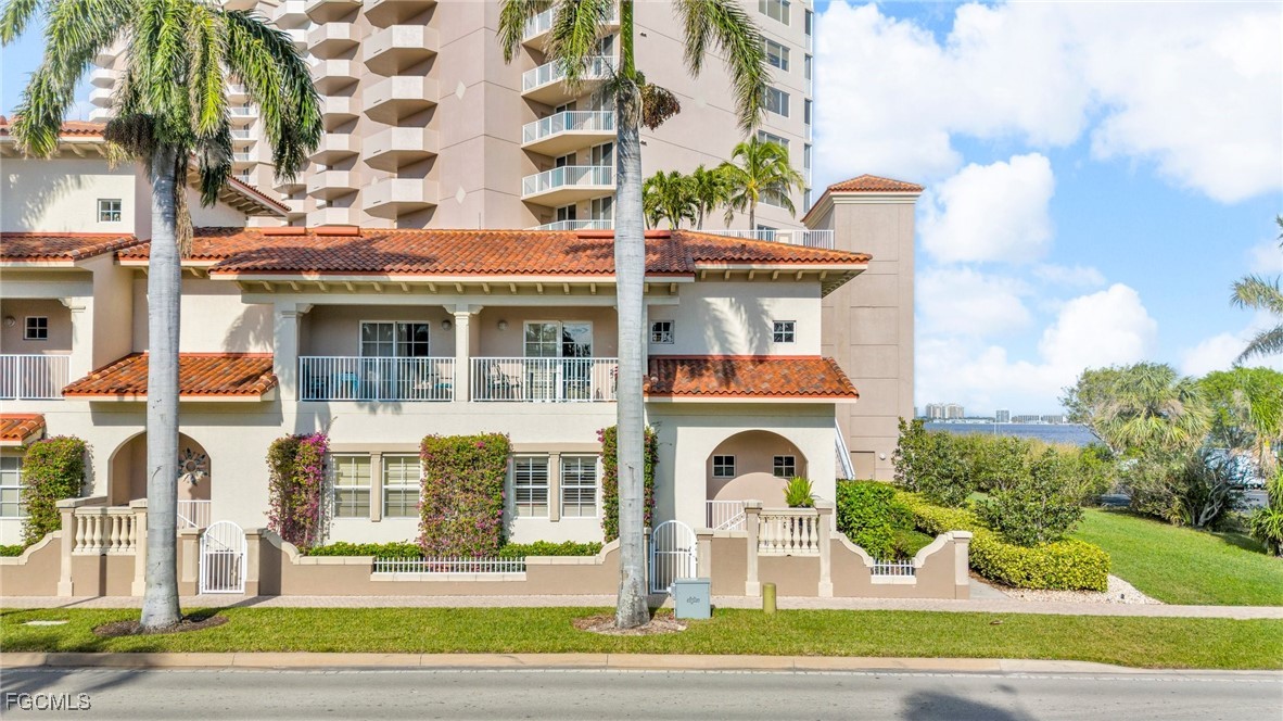 2080 West First Street, Unit 109 Fort Myers, FL 33901 - Photo 45 of 47 a front view of a multi story residential apartment building with yard