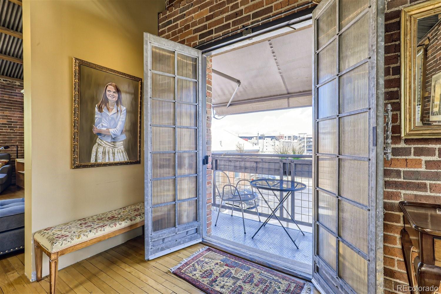 3349 Blake Street Denver, CO 80205 - Photo 15 of 28 a view of a hallway with wooden floor and a potted plant