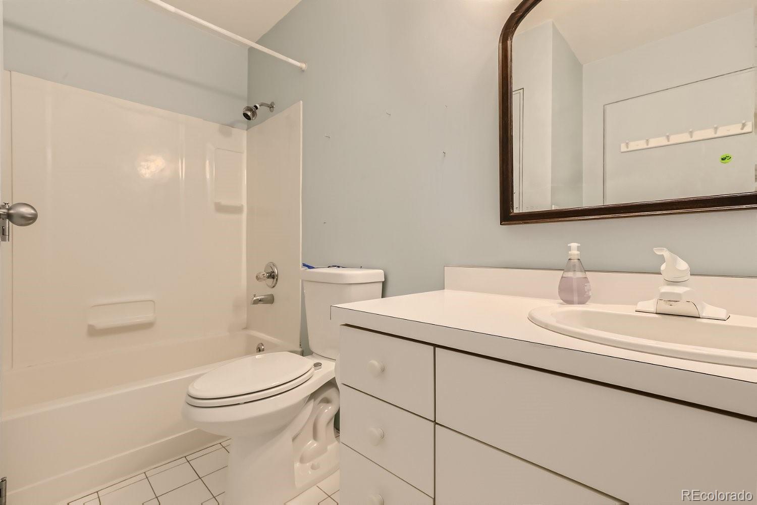3349 Blake Street Denver, CO 80205 - Photo 25 of 28 a bathroom with a toilet sink vanity and shower