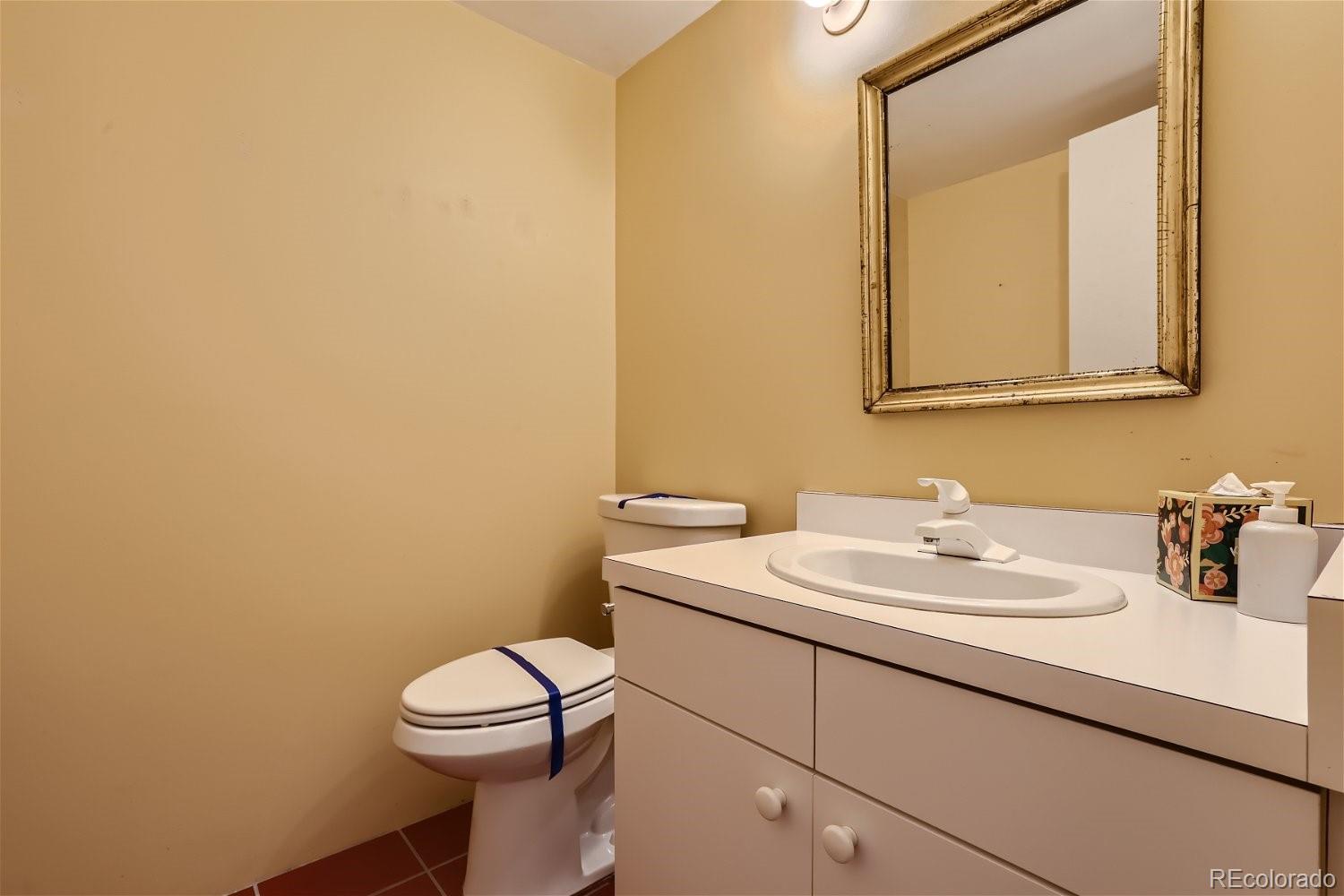 3349 Blake Street Denver, CO 80205 - Photo 9 of 28 a bathroom with a sink a toilet and mirror