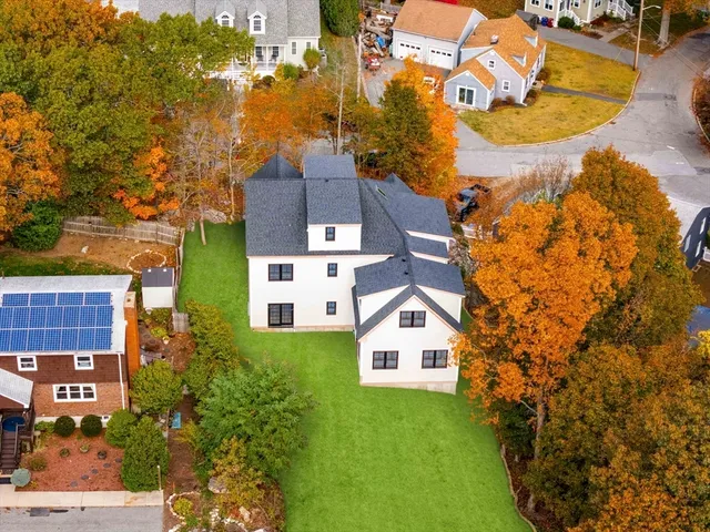 an aerial view of residential houses with outdoor space