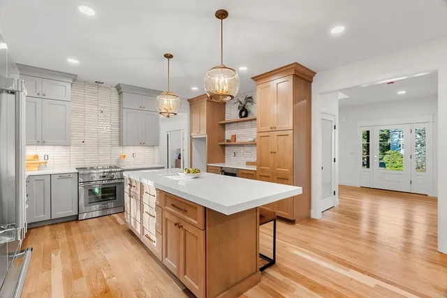 a kitchen with stainless steel appliances granite countertop a stove oven and a refrigerator