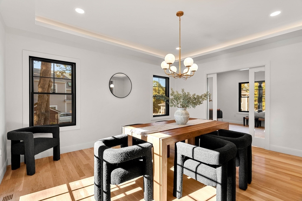 0 Beech Melrose, MA 02176 - Photo 10 of 17 a dining room filled chandelier and wooden floor