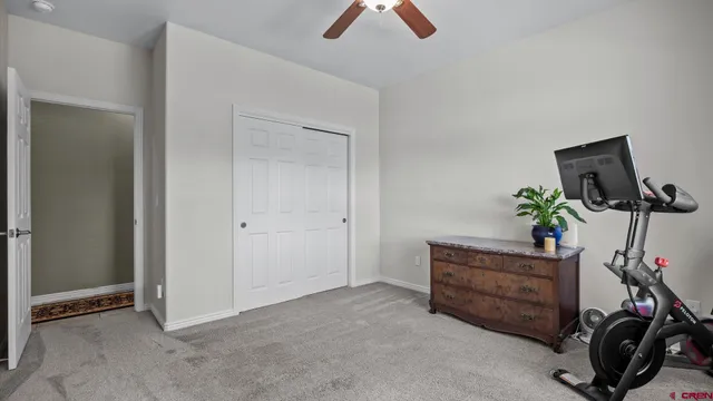 a view of a workspace with furniture and a potted plant